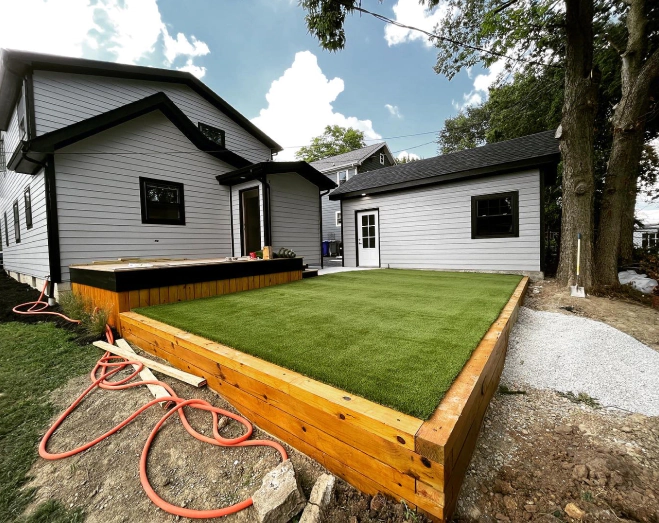 backyard patio made of wood and artificial turf